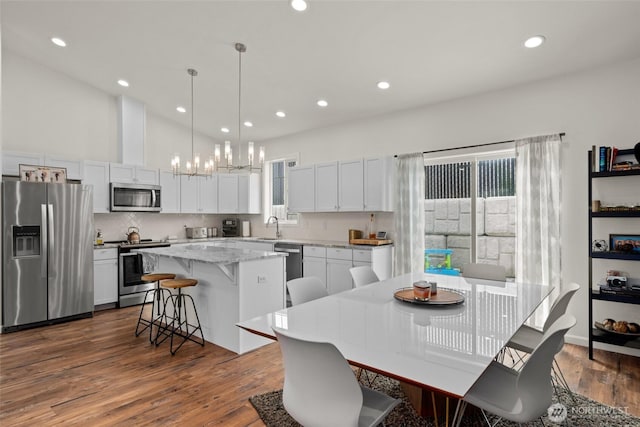 1828 Kristina Ln, Wenatchee, WA 98801 - dining space with a chandelier, dark wood-style floors, and recessed lighting