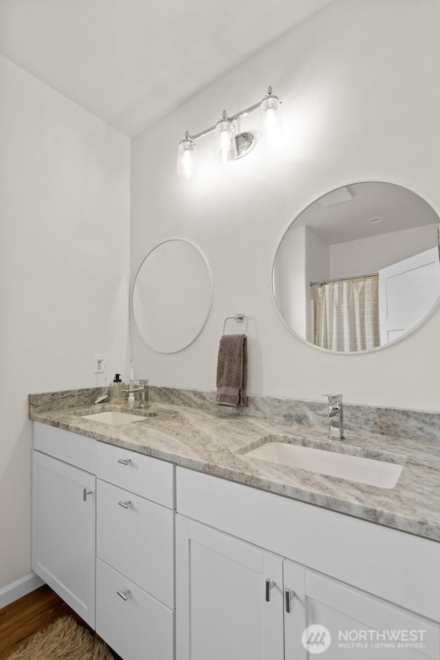 1828 Kristina Ln, Wenatchee, WA 98801 - bathroom featuring double vanity and wood finished floors
