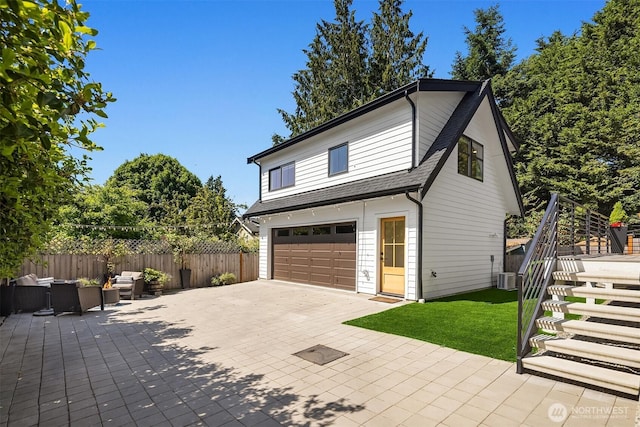 2809 NW 71st St, Seattle, WA 98117 - view of property exterior featuring an outdoor hangout area, a shingled roof, driveway, an attached garage, and stairway