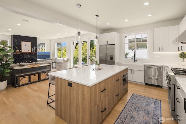 2809 NW 71st St, Seattle, WA 98117 - kitchen with high quality appliances, modern cabinets, recessed lighting, and a center island
