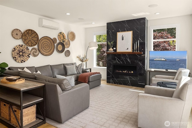 2809 NW 71st St, Seattle, WA 98117 - living area with a wall unit AC, a high end fireplace, recessed lighting, and wood finished floors
