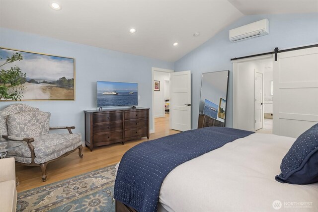 2809 NW 71st St, Seattle, WA 98117 - bedroom featuring a wall mounted AC, wood finished floors, a barn door, vaulted ceiling, and recessed lighting