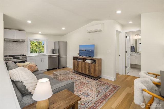 2809 NW 71st St, Seattle, WA 98117 - living area featuring a wall unit AC, recessed lighting, light wood-style flooring, and lofted ceiling