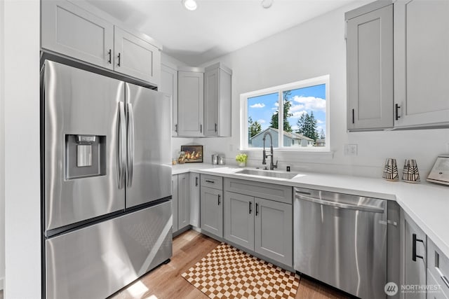 12107 E Gibson, Everett, WA 98204 - kitchen featuring appliances with stainless steel finishes, gray cabinetry, light countertops, light wood finished floors, and recessed lighting