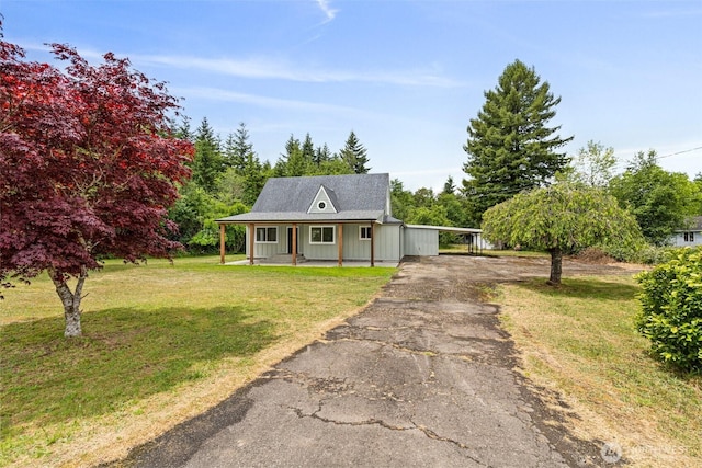 265 Knappton Rd, Naselle, WA 98638 - view of front of home with driveway, a porch, a front lawn, and a carport