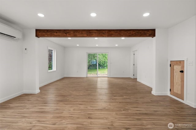 265 Knappton Rd, Naselle, WA 98638 - unfurnished room with a wall mounted AC, beam ceiling, light wood-style floors, and recessed lighting