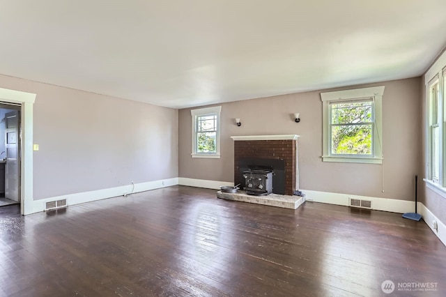 26405 Stephens St, Duvall, WA 98019 - unfurnished living room featuring a wood stove, plenty of natural light, and wood-type flooring