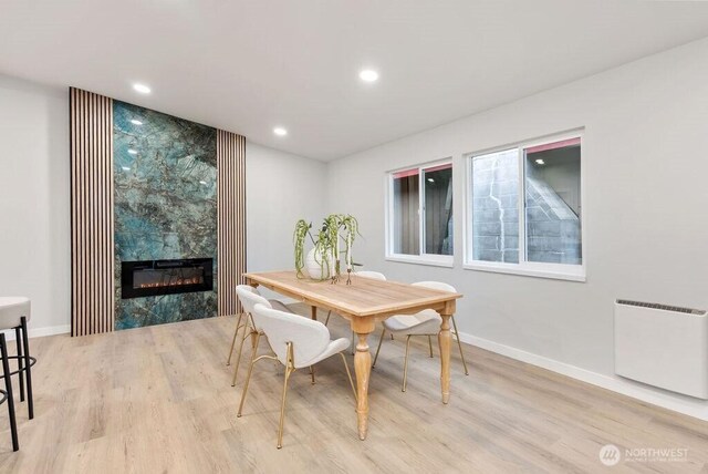 4968 Morgan Dr, Blaine, WA 98230 - dining room with radiator, wood finished floors, a fireplace, and recessed lighting