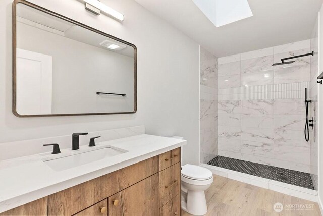 4968 Morgan Dr, Blaine, WA 98230 - bathroom featuring vanity, walk in shower, a skylight, and wood finished floors