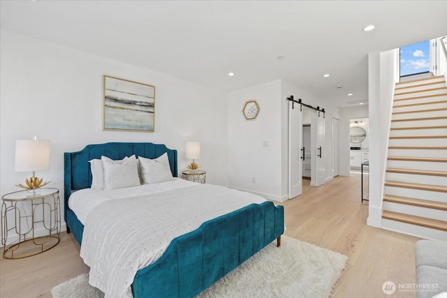 6032 42nd Ave SW Unit A, Seattle, WA 98136 - bedroom with a barn door, light wood finished floors, and recessed lighting