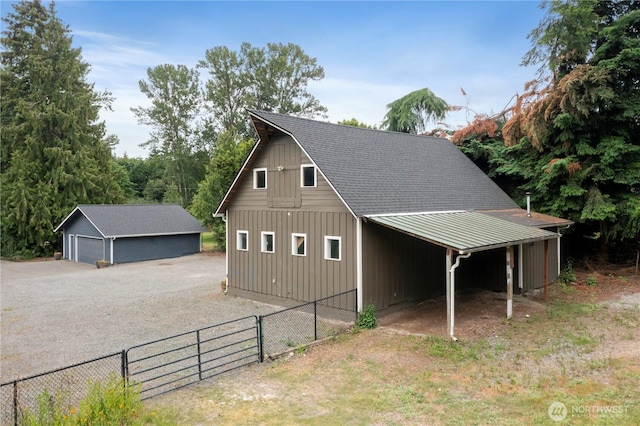 23305 98th Ave S, Kent, WA 98031 - view of side of home with a detached garage, an outbuilding, a metal roof, and roof with shingles