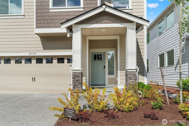 21124 42nd Dr SE, Bothell, WA 98021 - property entrance featuring an attached garage, driveway, and stone siding
