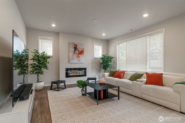 21124 42nd Dr SE, Bothell, WA 98021 - living room with wood finished floors, plenty of natural light, recessed lighting, and a glass covered fireplace