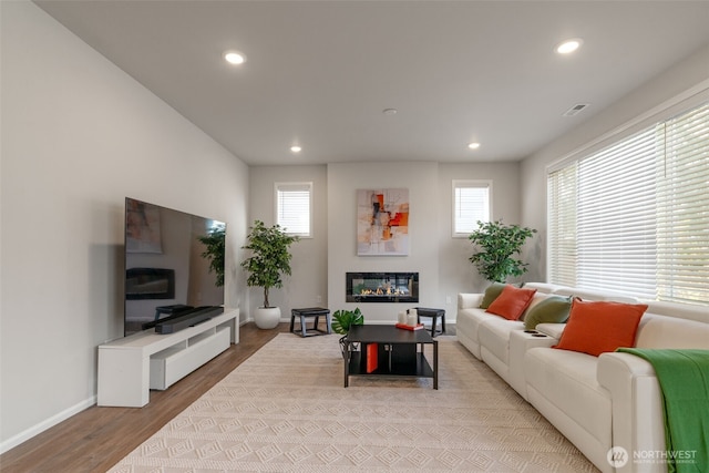 21124 42nd Dr SE, Bothell, WA 98021 - living area with a glass covered fireplace, recessed lighting, and wood finished floors