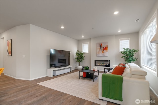 21124 42nd Dr SE, Bothell, WA 98021 - living room featuring a glass covered fireplace, wood finished floors, and recessed lighting