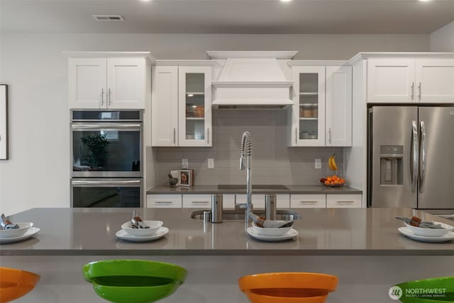 21124 42nd Dr SE, Bothell, WA 98021 - kitchen with stainless steel appliances, dark countertops, custom exhaust hood, white cabinets, and recessed lighting