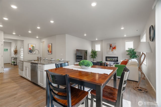 21124 42nd Dr SE, Bothell, WA 98021 - dining room featuring light wood finished floors, recessed lighting, and a glass covered fireplace