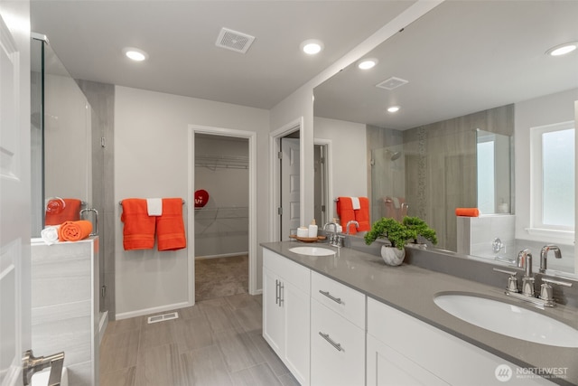 21124 42nd Dr SE, Bothell, WA 98021 - full bath with a stall shower, double vanity, a walk in closet, and recessed lighting
