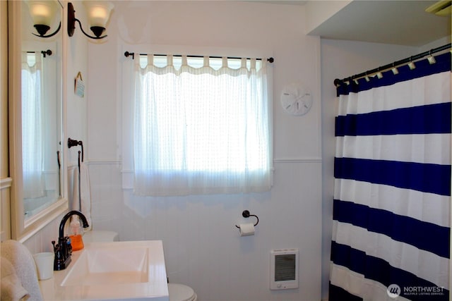 102 N 1st St, Pacific Beach, WA 98571 - full bathroom featuring heating unit, vanity, curtained shower, and a wainscoted wall
