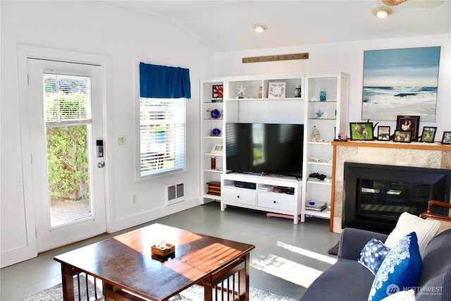 102 N 1st St, Pacific Beach, WA 98571 - living area with lofted ceiling, concrete flooring, and a glass covered fireplace