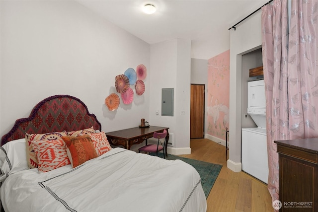 159 Denny Way Unit 112, Seattle, WA 98109 - bedroom with stacked washer and clothes dryer, light wood finished floors, and electric panel