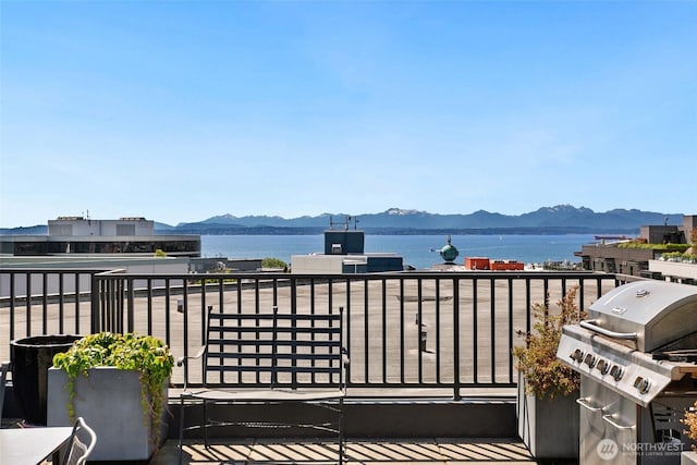159 Denny Way Unit 112, Seattle, WA 98109 - wooden terrace with a water and mountain view and a grill