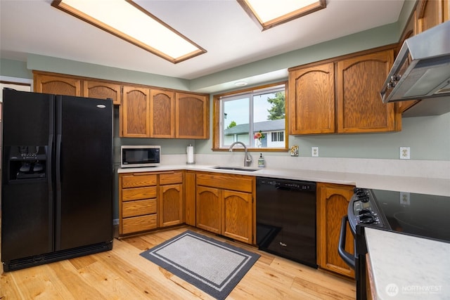 20063 Park Ridge Ln, Sedro Woolley, WA 98284 - kitchen featuring black appliances, range hood, light countertops, and light wood-type flooring