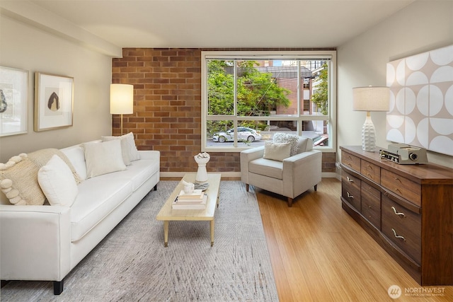 905 Cherry St Unit 101, Seattle, WA 98104 - living room featuring light wood finished floors and brick wall