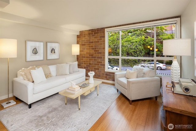 905 Cherry St Unit 101, Seattle, WA 98104 - living room with wood finished floors and brick wall