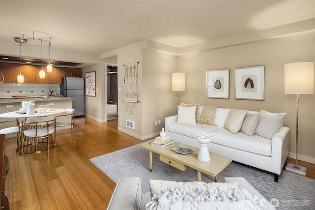 905 Cherry St Unit 101, Seattle, WA 98104 - living area with light wood-style floors and baseboards
