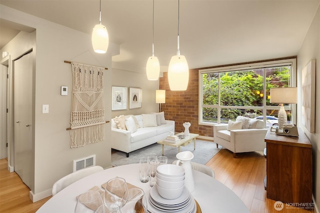 905 Cherry St Unit 101, Seattle, WA 98104 - living area with light wood-style floors and brick wall