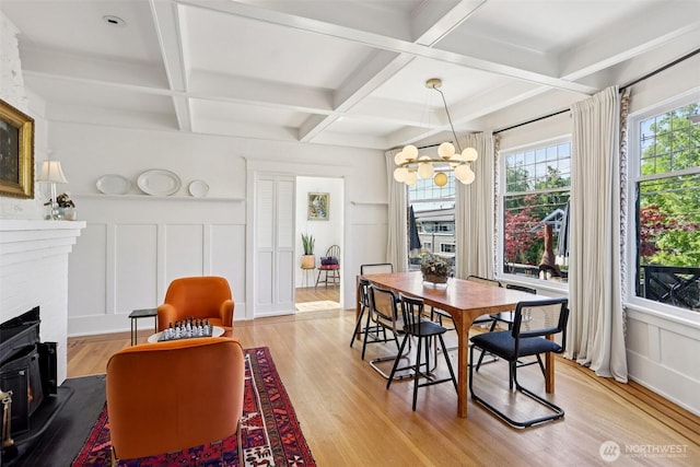2233 2nd Ave W, Seattle, WA 98119 - dining room featuring a decorative wall, light wood-style floors, coffered ceiling, a chandelier, and beamed ceiling