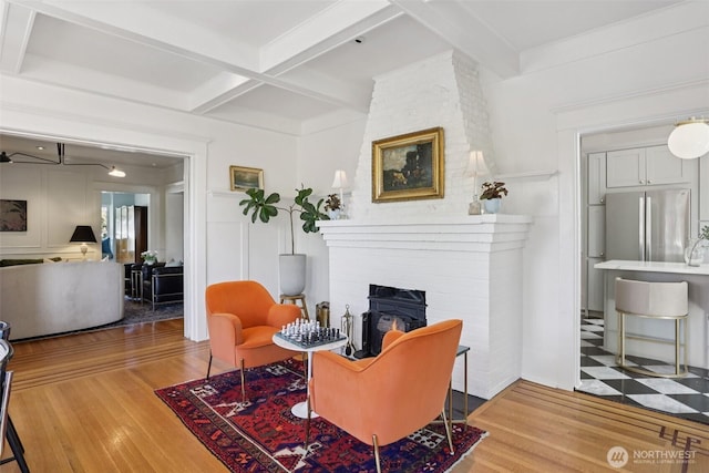 2233 2nd Ave W, Seattle, WA 98119 - living room featuring wood finished floors, beamed ceiling, a fireplace, and coffered ceiling
