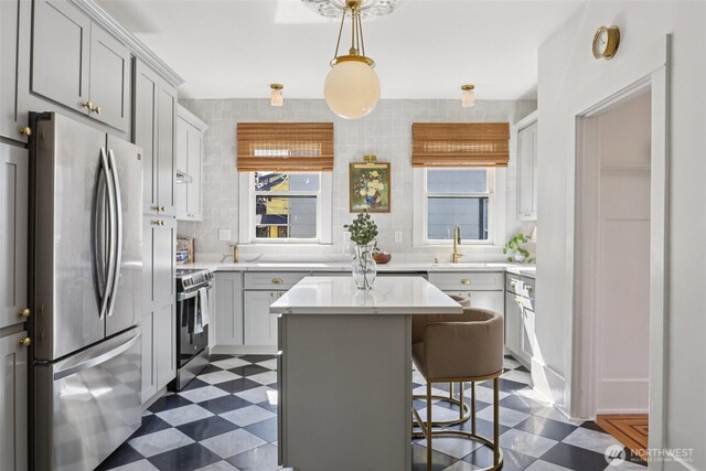 2233 2nd Ave W, Seattle, WA 98119 - kitchen with appliances with stainless steel finishes, dark floors, light countertops, and healthy amount of natural light