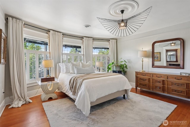 2233 2nd Ave W, Seattle, WA 98119 - bedroom with hardwood / wood-style flooring and a chandelier