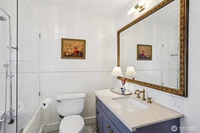 2233 2nd Ave W, Seattle, WA 98119 - full bathroom featuring tile walls, vanity, and combined bath / shower with glass door