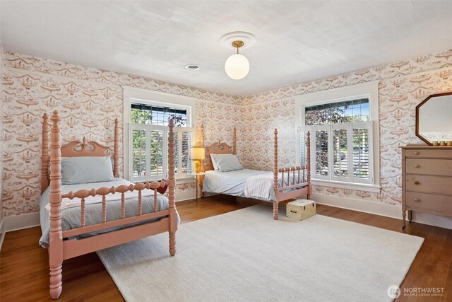 2233 2nd Ave W, Seattle, WA 98119 - bedroom featuring wallpapered walls and wood finished floors