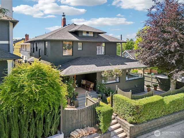 2233 2nd Ave W, Seattle, WA 98119 - view of front of property with roof with shingles, a chimney, and stucco siding