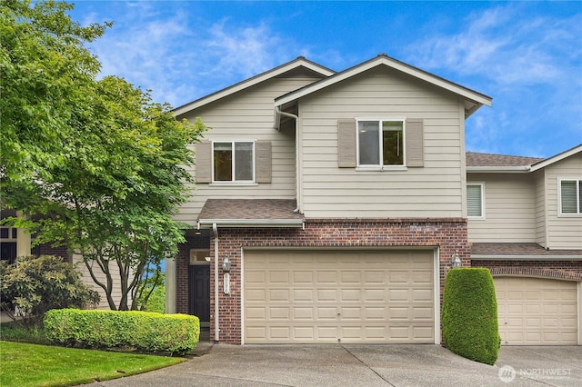 6290 Harbour Heights Parkway Unit A3, Mukilteo, WA 98275 - view of front of home with brick siding, an attached garage, driveway, and roof with shingles