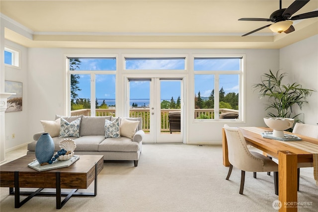 6290 Harbour Heights Parkway Unit A3, Mukilteo, WA 98275 - living area with ornamental molding, light carpet, a ceiling fan, and a raised ceiling