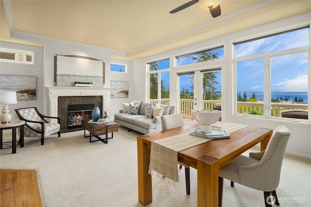 6290 Harbour Heights Parkway Unit A3, Mukilteo, WA 98275 - dining room with light carpet, ornamental molding, a tiled fireplace, and plenty of natural light