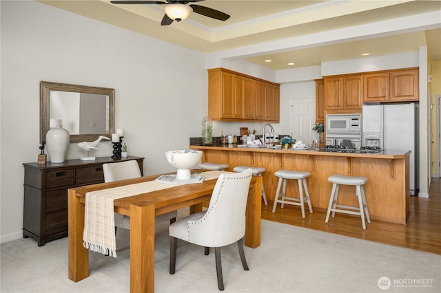 6290 Harbour Heights Parkway Unit A3, Mukilteo, WA 98275 - dining room featuring a ceiling fan, recessed lighting, crown molding, a tray ceiling, and light wood finished floors