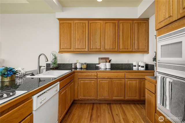 6290 Harbour Heights Parkway Unit A3, Mukilteo, WA 98275 - kitchen with white appliances, tile counters, brown cabinets, and light wood-type flooring