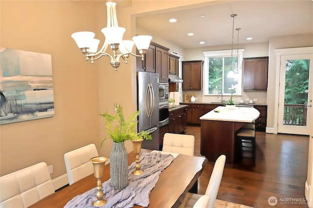 12265 168th Ct NE, Redmond, WA 98052 - kitchen featuring under cabinet range hood, a chandelier, appliances with stainless steel finishes, recessed lighting, and dark wood-style flooring