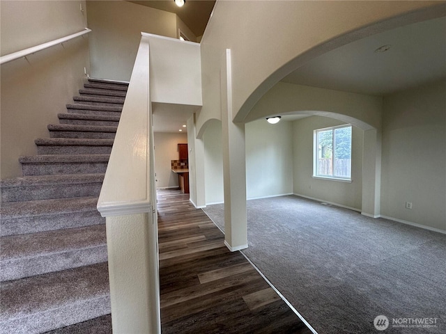 15328 104th Ave SE, Yelm, WA 98597 - staircase featuring arched walkways, wood finished floors, and carpet flooring