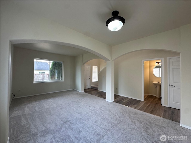 15328 104th Ave SE, Yelm, WA 98597 - unfurnished bedroom featuring arched walkways, carpet, and connected bathroom
