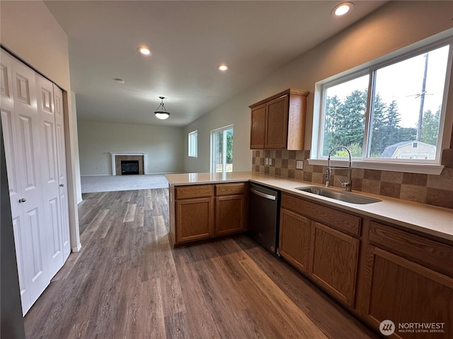 15328 104th Ave SE, Yelm, WA 98597 - kitchen featuring stainless steel dishwasher, dark wood-style floors, light countertops, a peninsula, and decorative backsplash