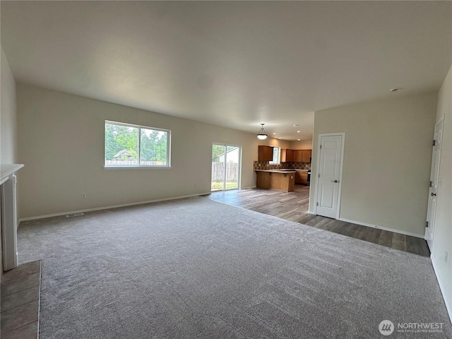 15328 104th Ave SE, Yelm, WA 98597 - unfurnished living room featuring carpet and baseboards