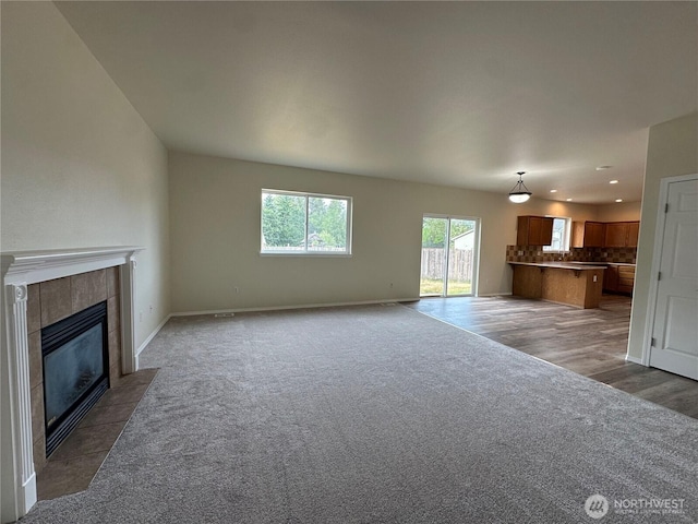 15328 104th Ave SE, Yelm, WA 98597 - unfurnished living room with carpet, a tile fireplace, and recessed lighting