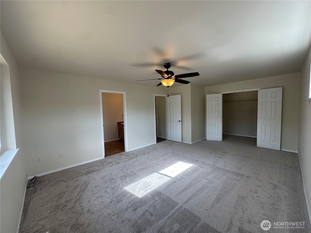 15328 104th Ave SE, Yelm, WA 98597 - unfurnished bedroom with carpet flooring, multiple closets, and ceiling fan